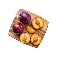 Obraz premium Fresh and Juicy Plums Arranged Beautifully on a Wooden Cutting Board
