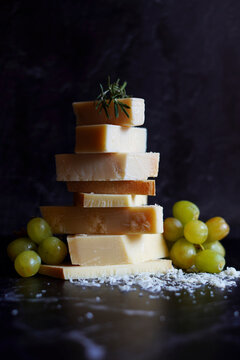 Italian aged gourmet cheeses, Parmigiano Reggiano and Gran Padano, with slices of aged Swiss Alpine cheese.