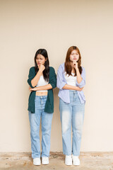 Fototapeta premium portrait of two teenage girls looking stressed while thinking