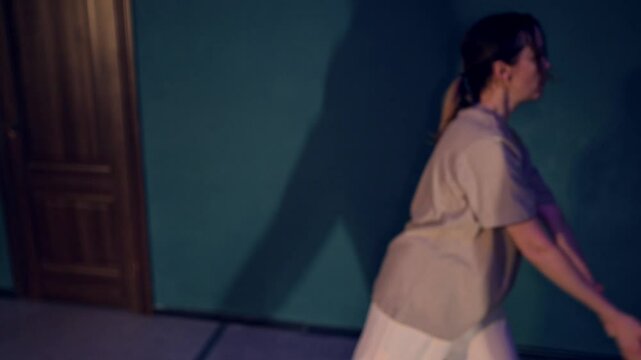 Two women dressed in beige clothes are performing a modern contemporary ballet duet filled with energy and grace. Caucasian ladies are demonstrating artistic skill through expressive movements