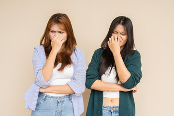 Bad smell and two women covering nose