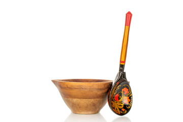 One painted wooden spoon with wooden cup isolated on white background, close-up.