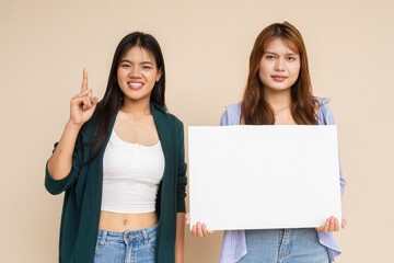 two young women holding blank placard