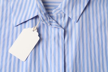 Cardboard tag on striped shirt, top view