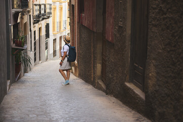 Woman Exploring Picturesque Narrow Streets of a Historic European City