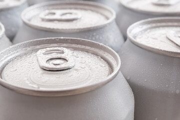 Close-up of cold beer cans with condensation and water drops.
