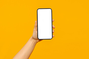 Woman hand holding smartphone with white empty screen for mobile application or website design,...