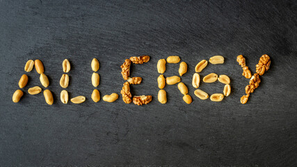 Nut allergy. The word ALLERGY is made up of various nuts. The concept of health. Immune system reaction, anaphylactic shock. Peanuts, Allergy symptoms and diagnosis. copy space, close up, flat lay