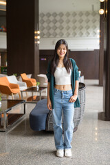 Full length portrait of a young woman in a restaurant