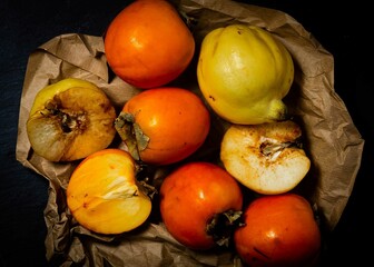 paper with persimmons in moody style
moody fruit paper with fresh persimmons