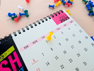 first July marked with push pin on calendar 2025
