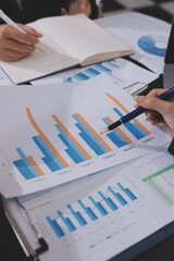 Team of business people working together in the meeting room office,
teamwork background charts and graphs banner, double exposure successful teamwork,business planning concept.