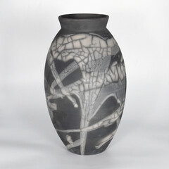 Oval ceramic black and white monochrome tall interior decorative raku vase on plain background