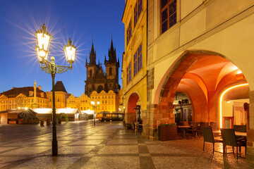 View of Old Town Square in Prague Czech Republic at dawn with Tyn Church and street lights