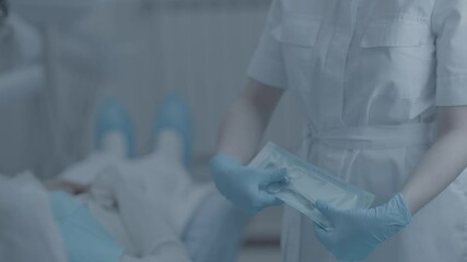 Close up view of medical professional showing right way to open sterilized dental anesthetic syringe - Powered by Adobe