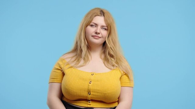 Overweight woman rolls eyes with frustrated expression, showing disapproval.