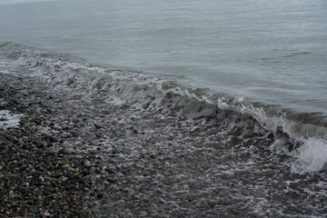 Outgoing wave on a stone beach in Batumi