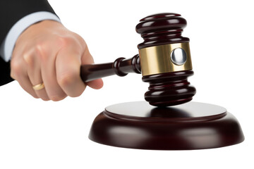 A hand in a suit sleeve holds a wooden and silver gavel above its striking block, isolated on white, signifying legal proceedings on transparent background