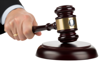 A hand in a suit sleeve holds a wooden and silver gavel above its striking block, isolated on white, signifying legal proceedings on transparent background