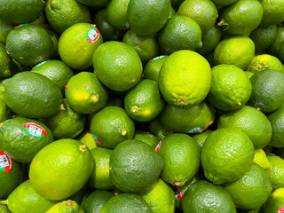Oklahoma, USA - March 21, 2022: A pile of limes on the shelf in a supermarket. Oklahoma, USA