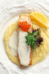 Portion of gourmet salmon fillet steak with creamy sauce