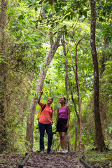 Two woman trekking in tropical rainforest, Metropolitan Natural Park, Panama City, Panama - stock photo