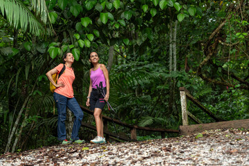 Two woman trekking in tropical rainforest, Metropolitan Natural Park, Panama City, Panama - stock photo