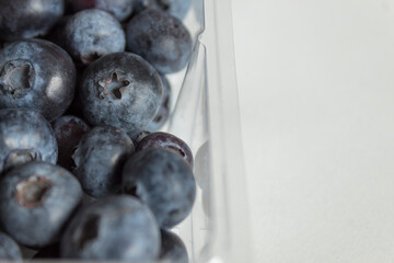 Blueberries in a plastic bow bought from the market.