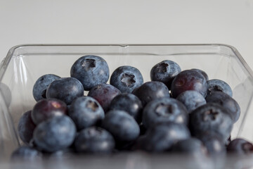 Blueberries in a plastic bow bought from the market.