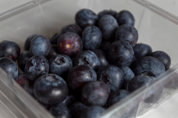Blueberries in a plastic bow bought from the market.