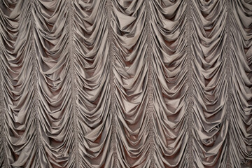 Obraz premium Elegant draped fabric in soft beige colors creating a textured backdrop