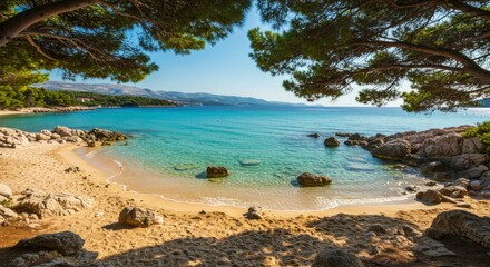 Fototapeta premium Secluded cove with crystal-clear turquoise water, sandy beach, and pine trees overhead