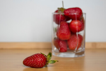Glass cup full of strawberries.