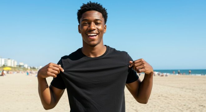 Man showing blank t-shirt on beach