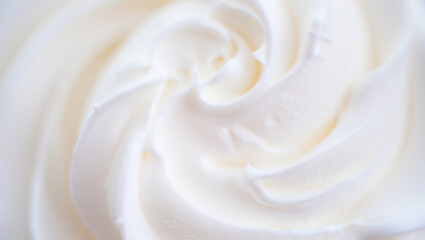 Close up of smooth creamy and swirled white frosting or icing texture