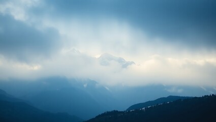 Obraz premium Misty Mountain Peaks in a Tranquil Blue Light Background image