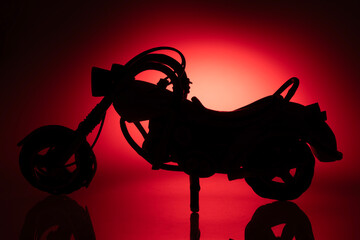 Silhouette of  a motorcycle model in red lightning