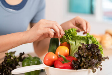 ESG and Fresh Produce. Woman arranging colorful vegetables in a bowl.