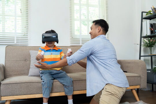 Interactive Family Fun and Virtual Reality. A child experiences virtual reality while a father supports him in a playful moment.