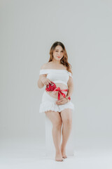 Expectant Woman Holding Baby Shoes