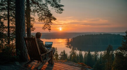 Young professional using laptop at sunset in Finland, enjoying freedom and stunning view of lake and forest