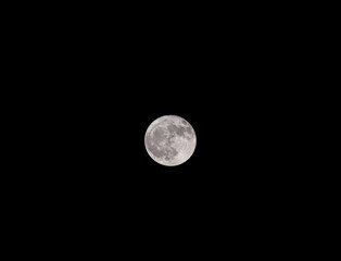 Full moon on the dark black sky.