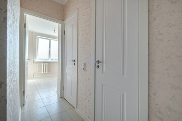 modern door handle on white wooden door in interior. Knob close-up elements. Door handle, fittings for interior design