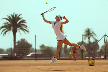 Woman tennis player plays tennis on the tennis court.