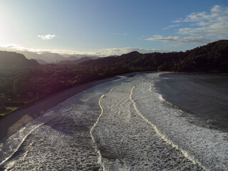 Deserted Barra do Sahy beach at dawn with small waves