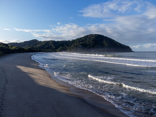 Deserted Barra do Sahy beach at dawn with small waves