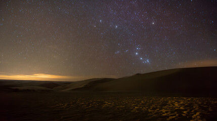 Fototapeta premium Night Sky with Bright Stars Over Desert Dunes in Dark Calm Atmosphere