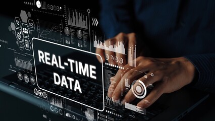 Hands Typing on Laptop with Digital Graphics Representing Real-Time Data Analysis and Technology...