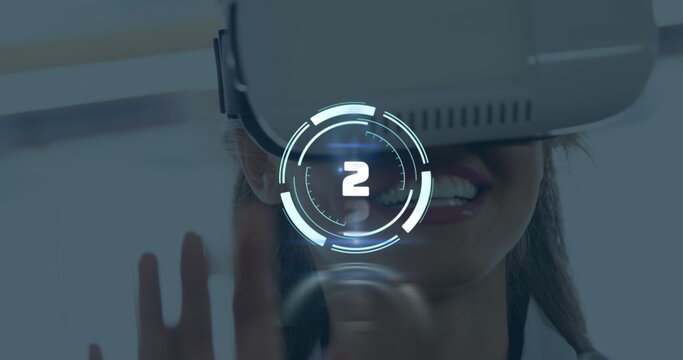 Smiling woman wearing white VR headset using holographic countdown HUD at tech demo, hand gesture