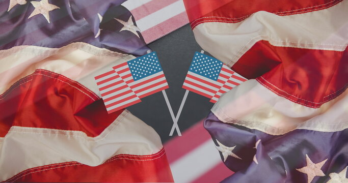 Naklejki Displaying two crossed United States flags forming X in graphic art, with billowing flag fabric